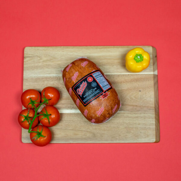 Pork Boneless Banquet Style Smoked Ham on cutting board next to vegetables