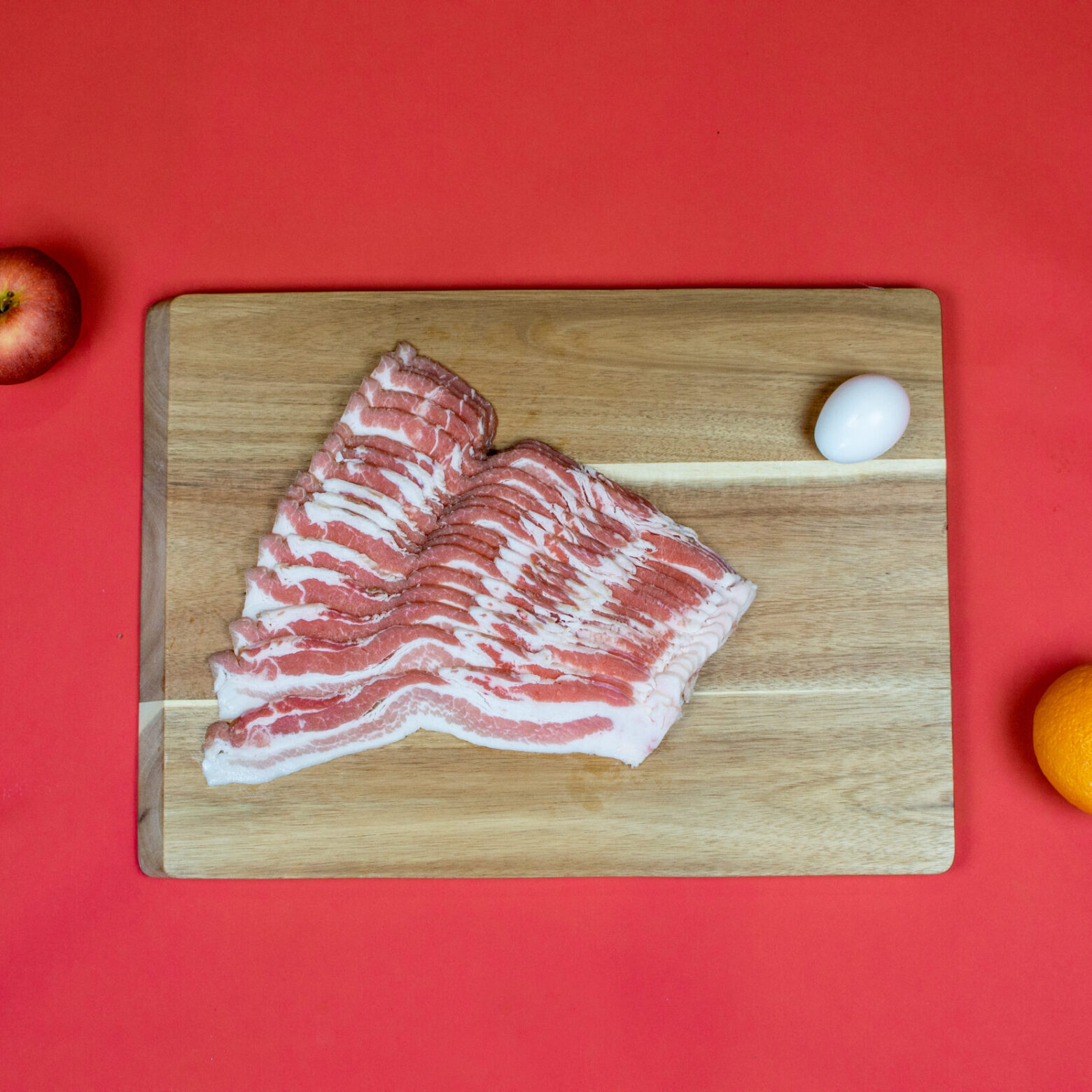 Bulk fresh side pork bacon laid out on cutting board